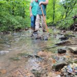 Man & Woman standing in creek