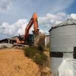 Track Hoe Near Grain Bin